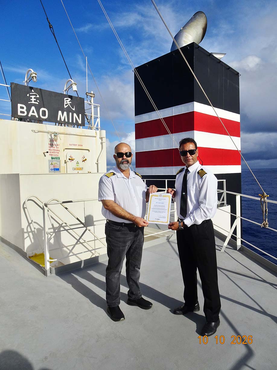 Captain Ranawat and Chief Engineer Mohit holding the NYK Dry Bulk Award Gold certificate aboard M/V BAO MIN